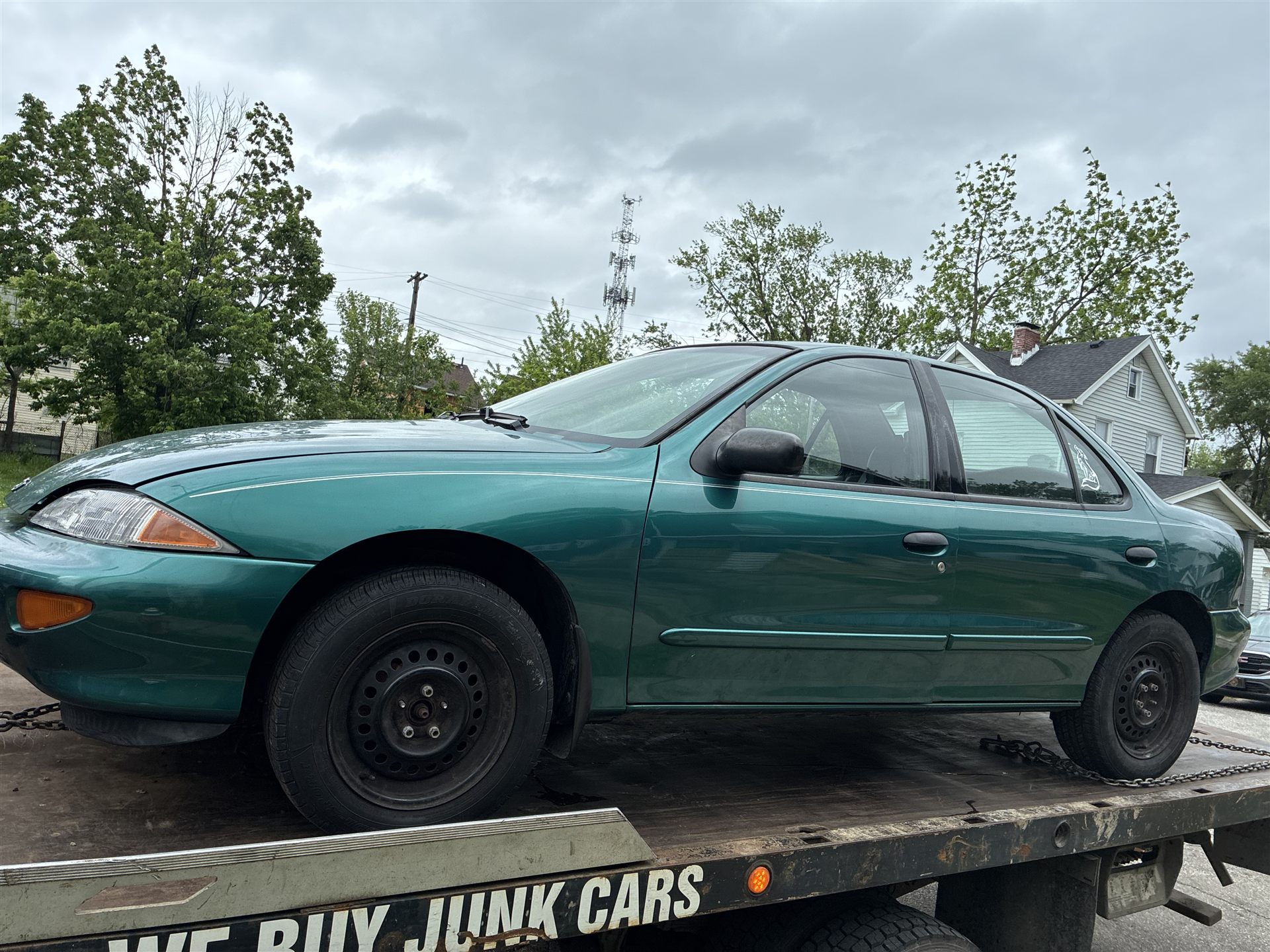 Green sedan loaded on an Up the Way Auto Removal flatbed